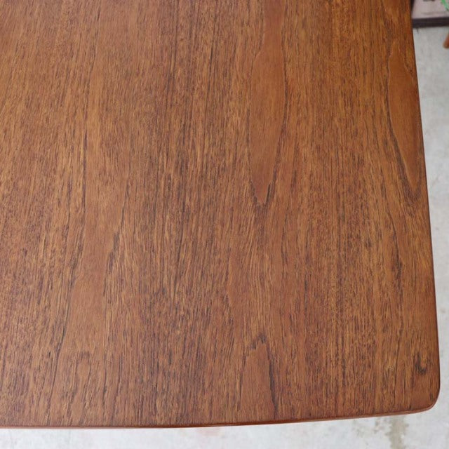 Vintage British mid-century teak dining table top showing rich wood grain and smooth rectangular edges.