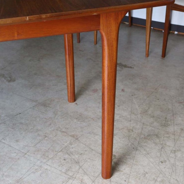 Vintage mid-century British teak dining table by McIntosh with smooth wood grain and tapered legs from Denmark style.