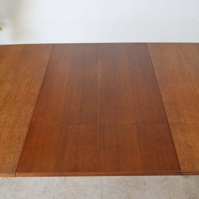 Vintage mid-century teak dining table by McIntosh with rich wood grain and tapered legs, British design from Denmark.