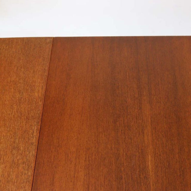 Vintage mid-century British teak dining table with smooth wood grain and rectangular top.