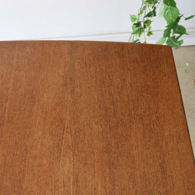 Mid-century British vintage teak dining table with smooth rectangular top and subtle wood grain detail.