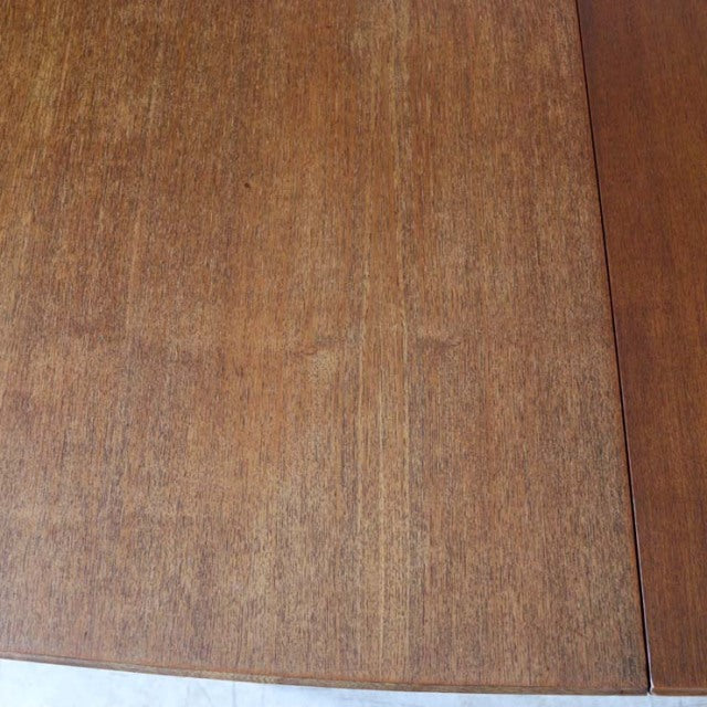 Mid-century British vintage teak dining table top showing rich wood grain and smooth finish.