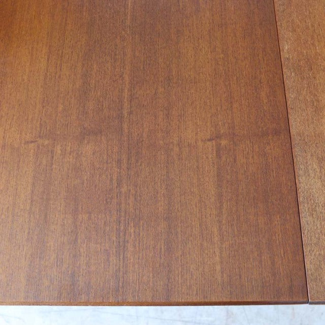 Vintage mid-century British teak dining table top showcasing rich wood grain and smooth finish.