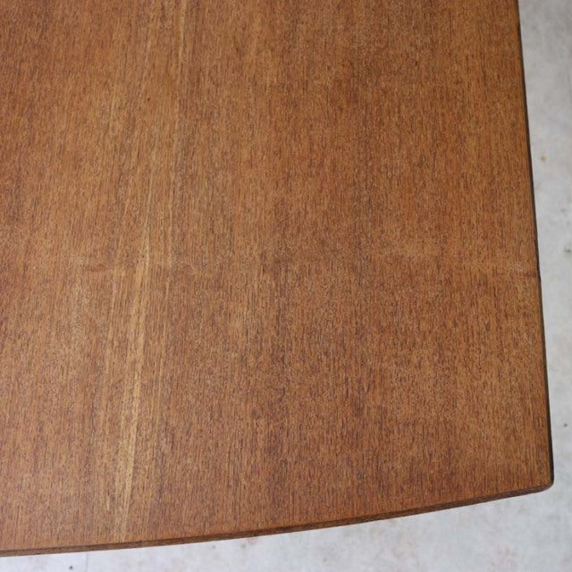 Vintage McIntosh teak dining table corner showing smooth wood grain and mid-century British design from Denmark.