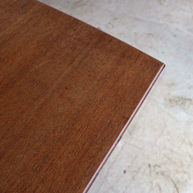 Corner close-up of vintage teak dining table showcasing smooth wood grain and mid-century British craftsmanship.