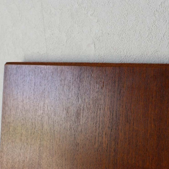 Vintage British mid-century teak dining table corner with rich wood grain and smooth rectangular edge.
