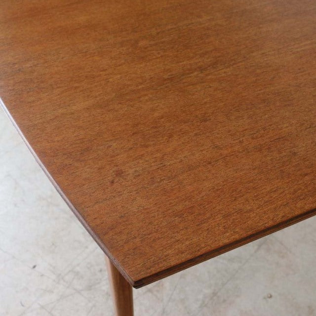 Vintage McIntosh mid-century teak dining table top showing rich wood grain and clean rectangular edges.