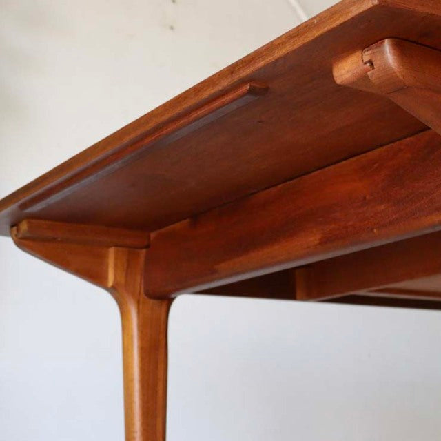 Mid-century British vintage teak dining table with smooth wood grain and tapered legs, McIntosh design from Denmark.