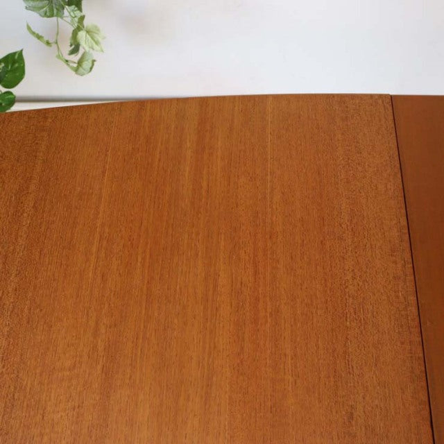 Mid-century vintage British McIntosh teak dining table top showcasing smooth wood grain and warm honey tones.