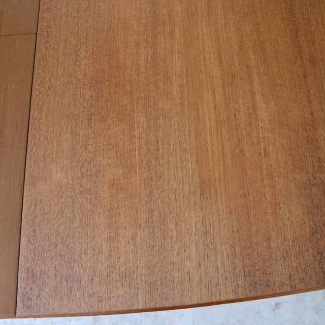 Mid-century vintage teak dining table top with fine wood grain, British McIntosh design, smooth rectangular surface.