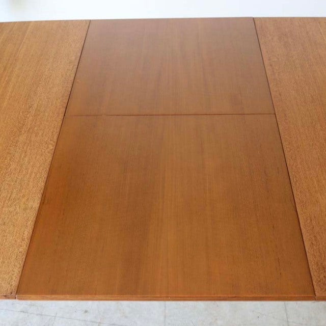 Vintage teak mid-century British dining table by McIntosh with smooth wood grain and rectangular top.