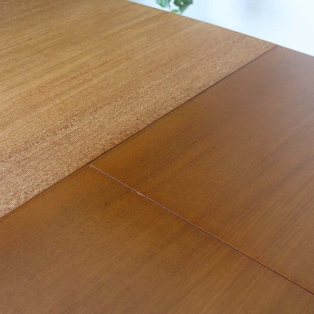 Mid-century British vintage teak dining table with rich wood grain and smooth rectangular surface.