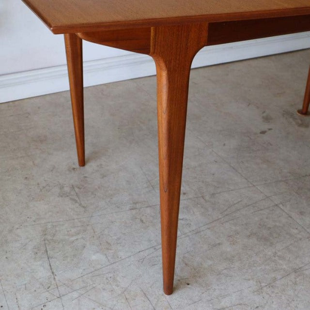 Vintage mid-century McIntosh dining table in teak with tapered square legs and smooth wood grain, British design with Danish .