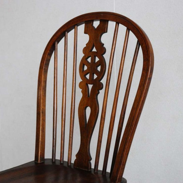Vintage British teak kitchen chair with curved spindle backrest and decorative central splat in mid-century style from.