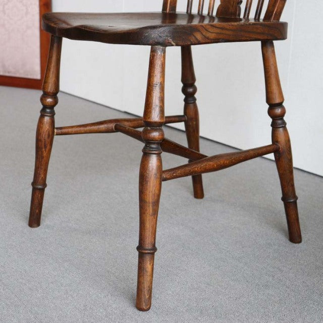 Vintage teak British mid-century kitchen chair with turned legs and cross stretcher detailing.