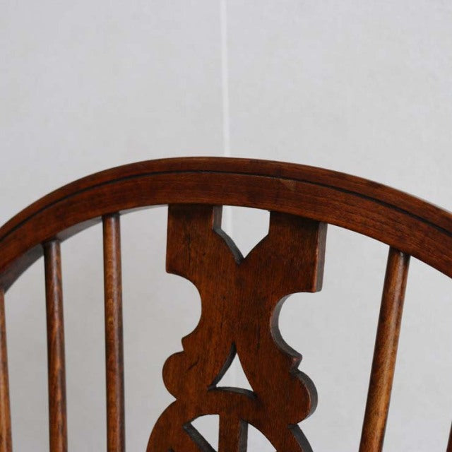 Vintage British teak kitchen chair backrest with curved top rail and decorative central splat, mid-century design.