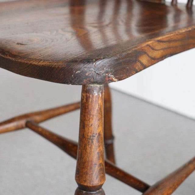 Vintage teak British mid-century kitchen chair leg with visible wood grain and rounded edges.