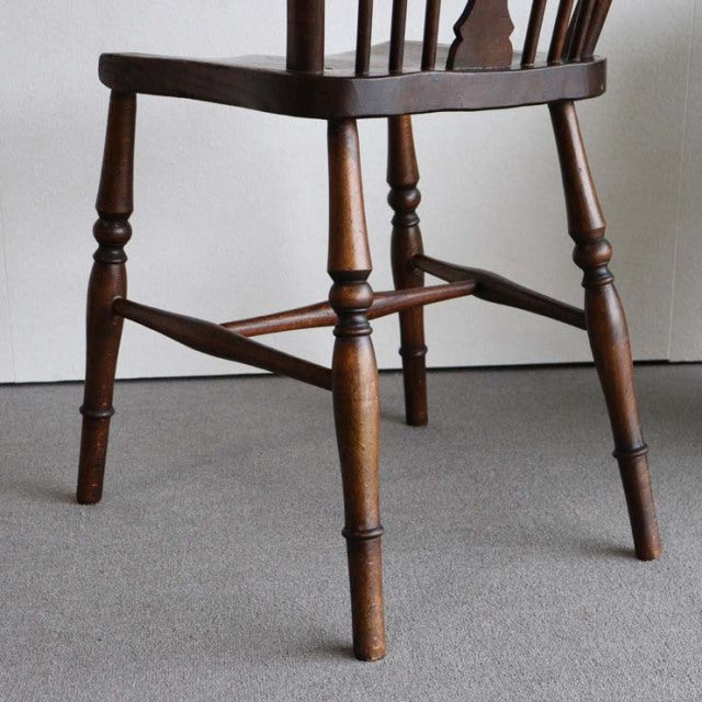 Vintage teak British mid-century kitchen chair with turned legs and spindled stretchers, Danish influence visible in smooth.