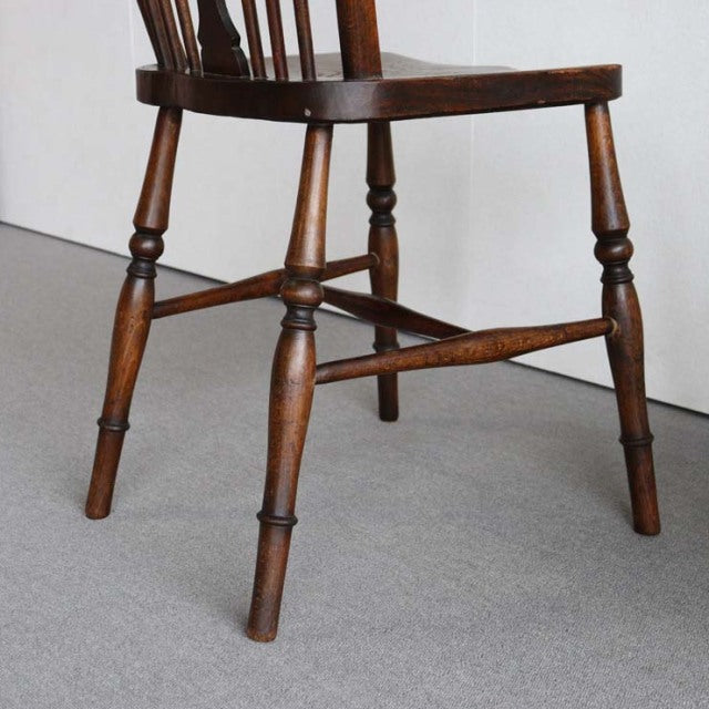 Vintage British teak kitchen chair with turned legs and spindled backrest in mid-century style.