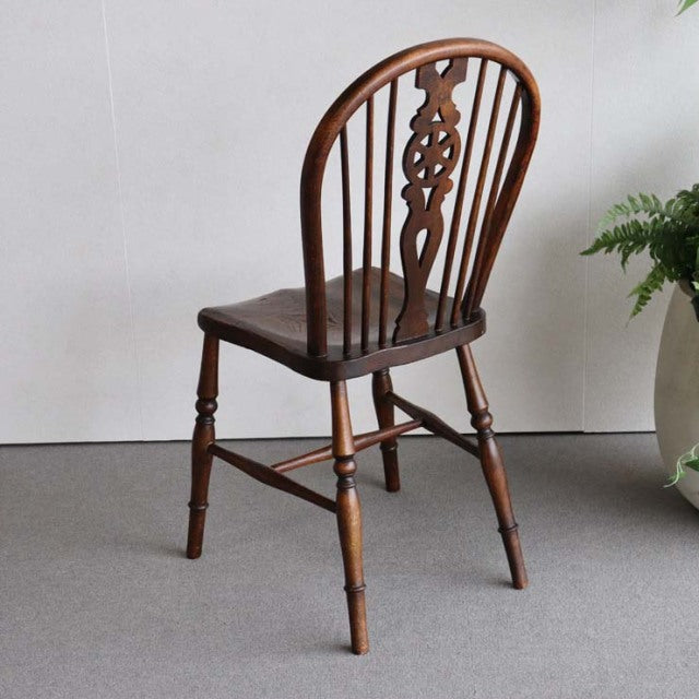 Vintage British teak kitchen chair with carved spindle back and turned legs, mid-century Denmark style.