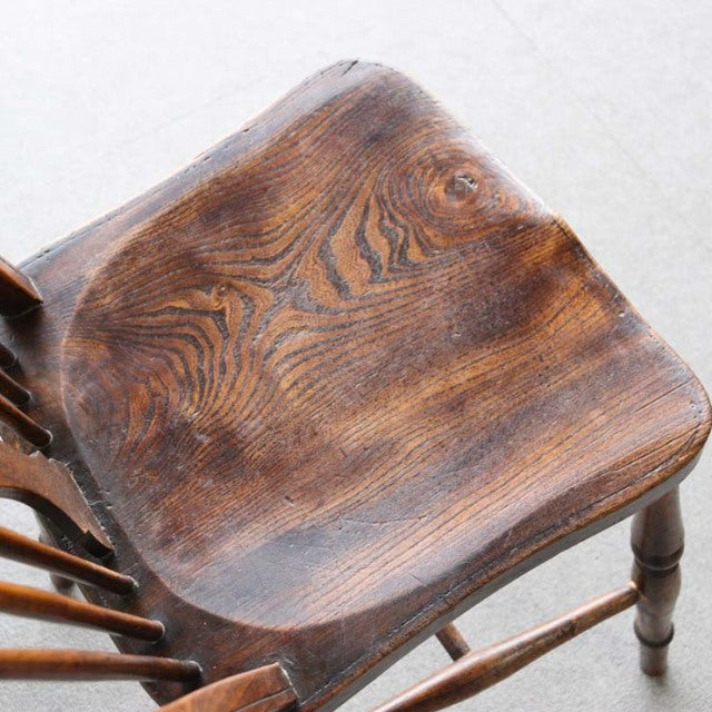 Vintage teak dining chair seat with smooth wood grain and mid-century British craftsmanship details.