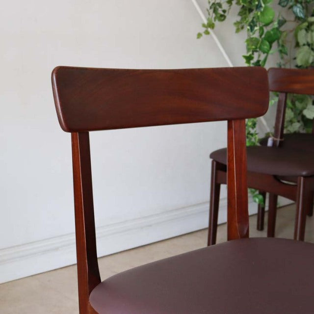 Vintage teak mid-century dining chair with British design, featuring smooth wood grain and tapered legs from Denmark style.