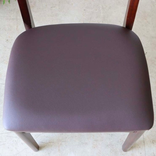 Vintage British mid-century dining chair with teak frame and smooth dark brown seat cushion, slender legs.