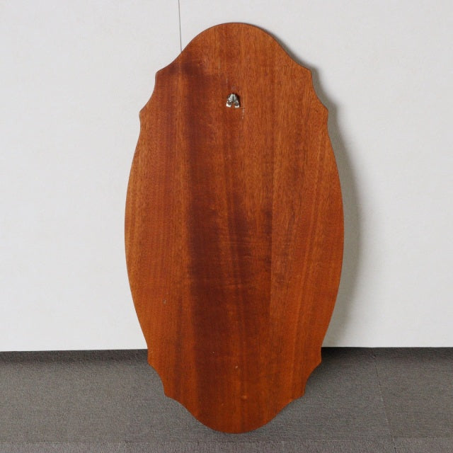 Vintage British mid-century teak wall mirror with an elongated oval shape and smooth wood grain finish.