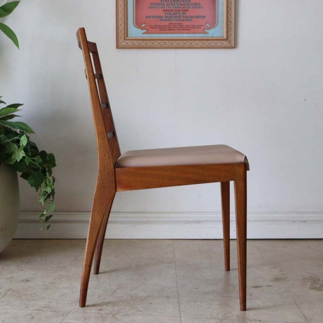 Mid-century British vintage teak dining chair by McIntosh with slender legs and smooth wood grain.