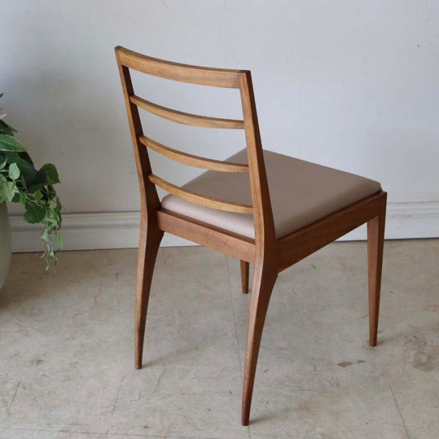 Set of four vintage McIntosh teak dining chairs with mid-century British design, ladder back and tapered legs.