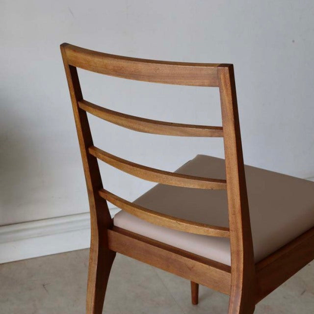 Mid-century British vintage teak dining chair with horizontal slatted back and beige cushioned seat.