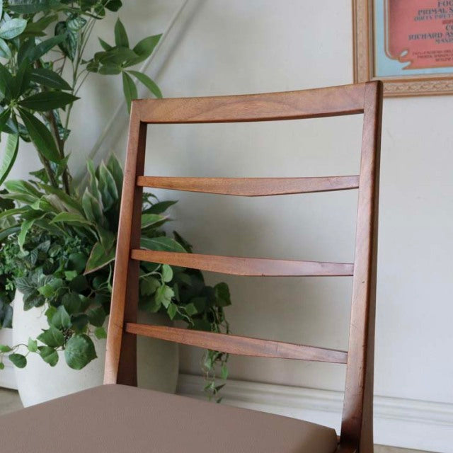 Set of four vintage mid-century British teak dining chairs by McIntosh with ladder-style backs and tapered legs.