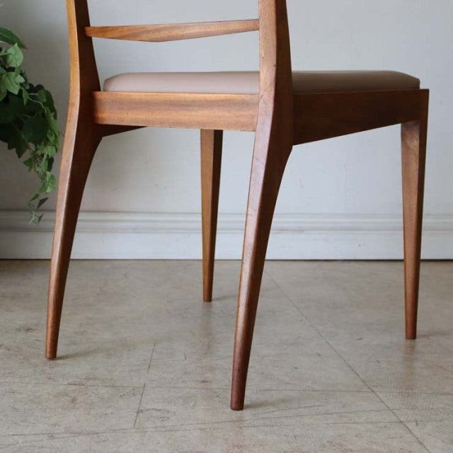 Set of four vintage teak McIntosh mid-century British dining chairs with sleek, tapered legs and minimalist backrest design.