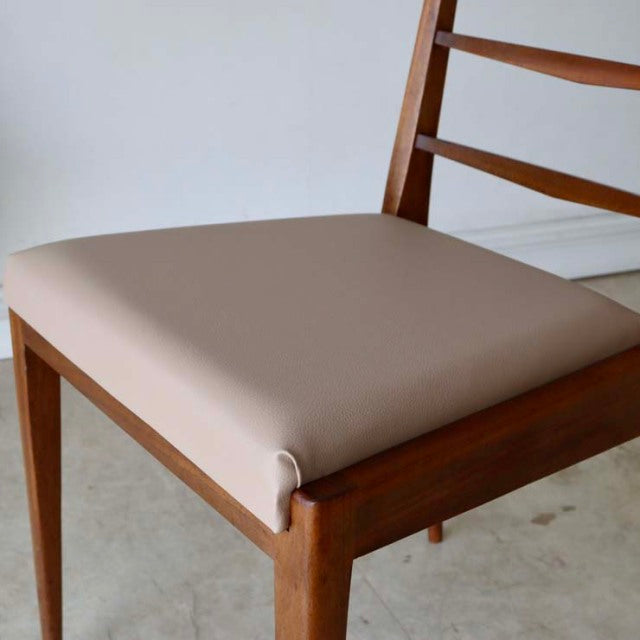 Vintage mid-century McIntosh teak dining chair with ladder back and beige upholstered seat.