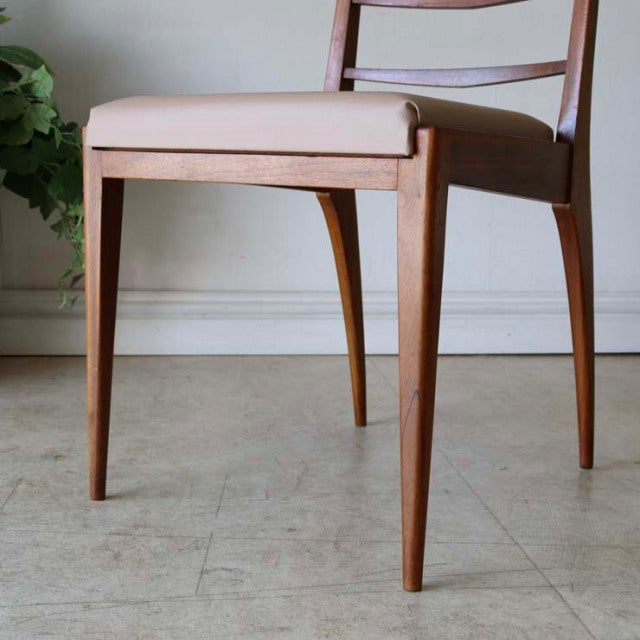 Set of four vintage McIntosh thin ladder dining chairs in teak with slim tapered legs and beige upholstered seats,.