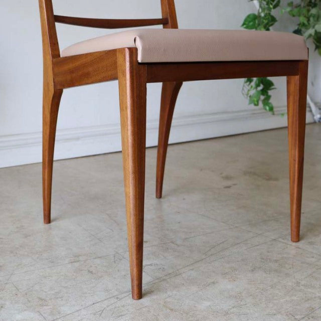 Vintage mid-century teak dining chair from British McIntosh with tapered legs and beige upholstered seat, Danish-inspired.