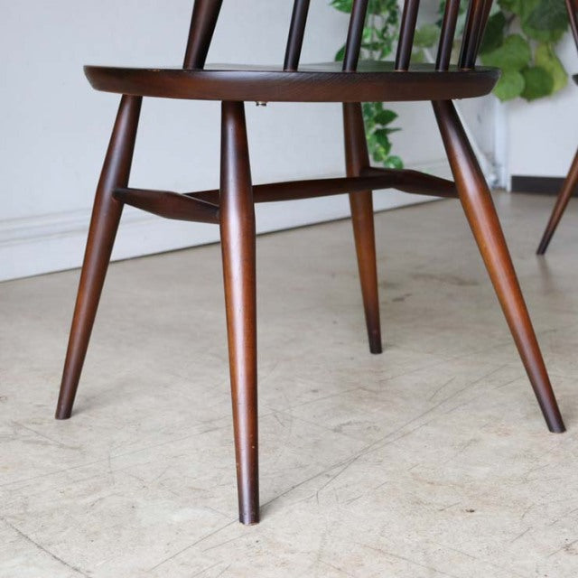 Mid-century British vintage Ercol Goldsmith dining chair in teak with tapered legs and visible wood grain.