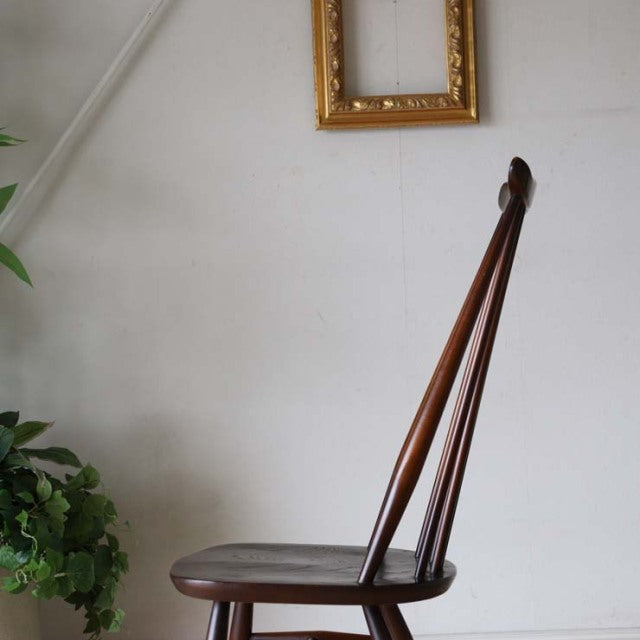 Mid-century British vintage ERCOL dining chair in rich teak with slender spindle back and gently curved seat.