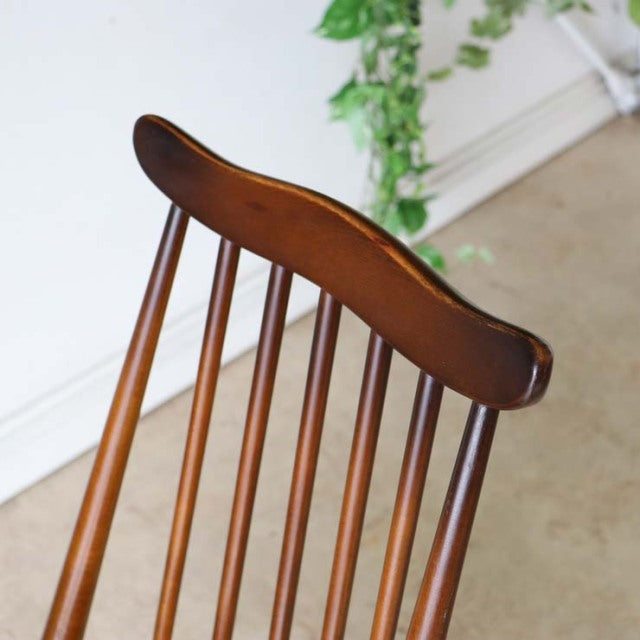Pair of vintage ERCOL Goldsmith highback dining chairs in rich teak with curved top rail, slender spindled back, and tapered .
