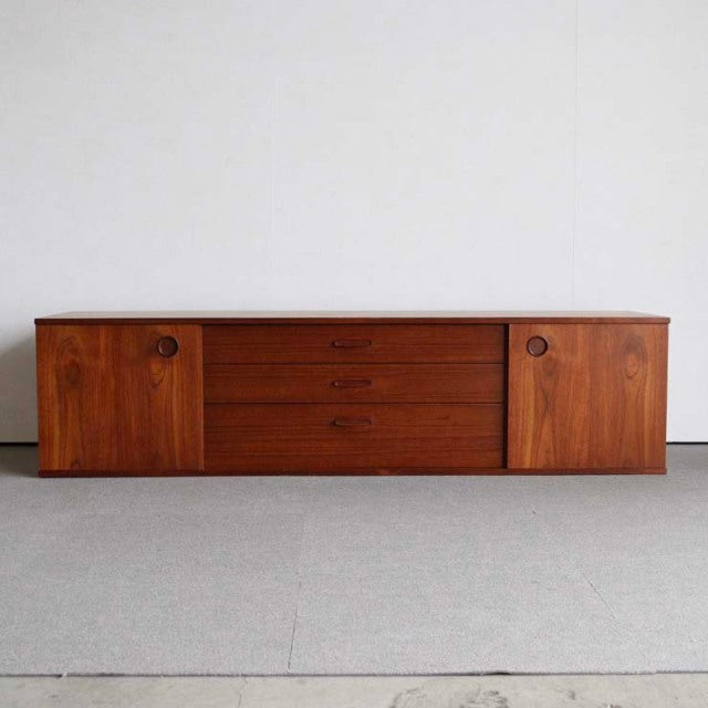 Vintage teak sideboard by Avalon with mid-century British design, featuring rich wood grain, three central drawers, and two.
