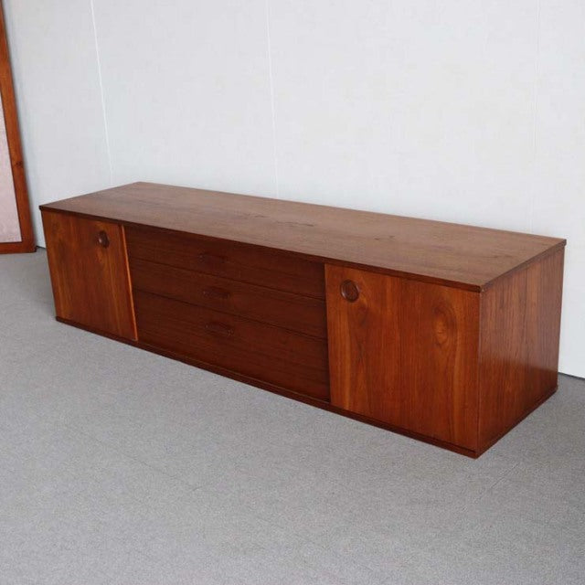 Vintage teak sideboard by Avalon with rich wood grain, mid-century British design, low profile with circular handle details.