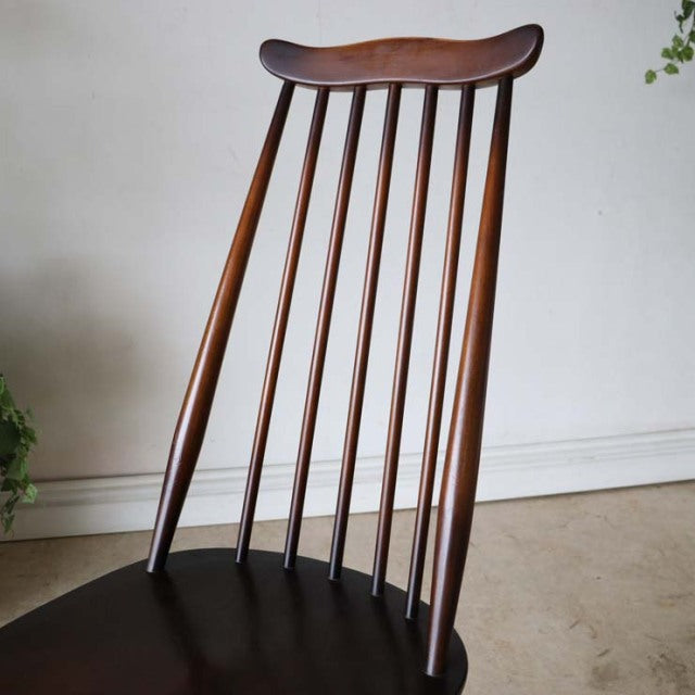 British vintage mid-century teak dining chair with elegant curved spindle back and tapered legs.