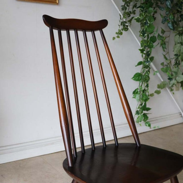 Vintage British mid-century Ercol Goldsmith dining chair in rich teak with elegant spindle back and curved seat.
