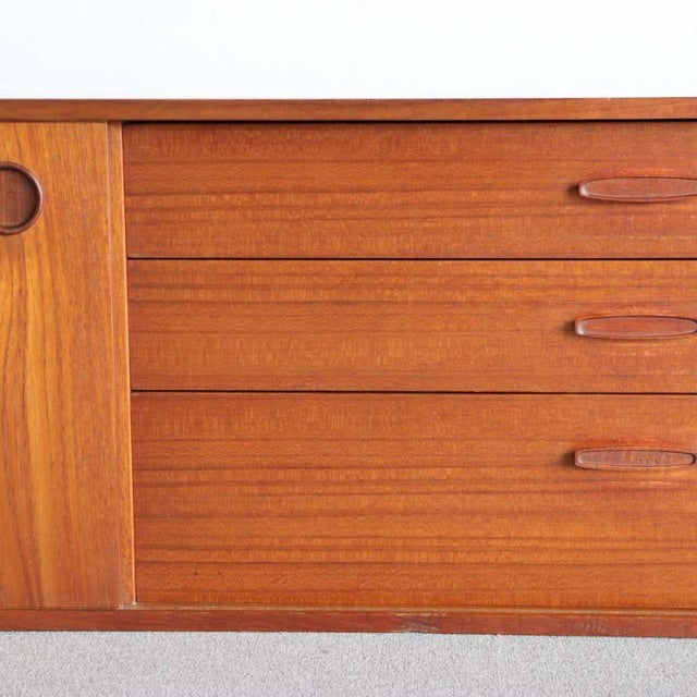 Mid-century British teak sideboard by AVALON with rich wood grain, rounded handles, and smooth drawer fronts.