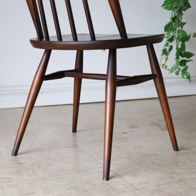 ERCOL Goldsmith highback Windsor chair in polished teak with slender tapered legs and vintage mid-century British design.