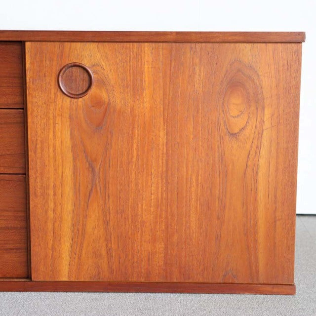 Mid-century British teak sideboard door with circular recessed handle, rich wood grain, smooth finish, Avalon design.