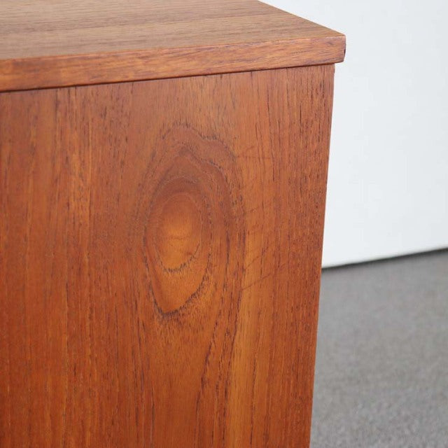 Close-up of vintage teak sideboard corner showing rich wood grain and smooth mid-century British design from AVALON.