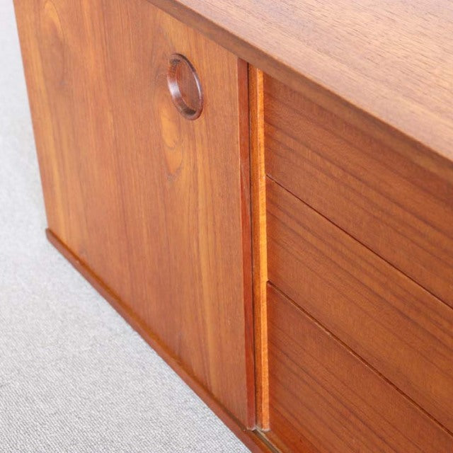 Mid-century British teak sideboard by Avalon with smooth wood grain, round recessed handle, and clean-lined drawers.