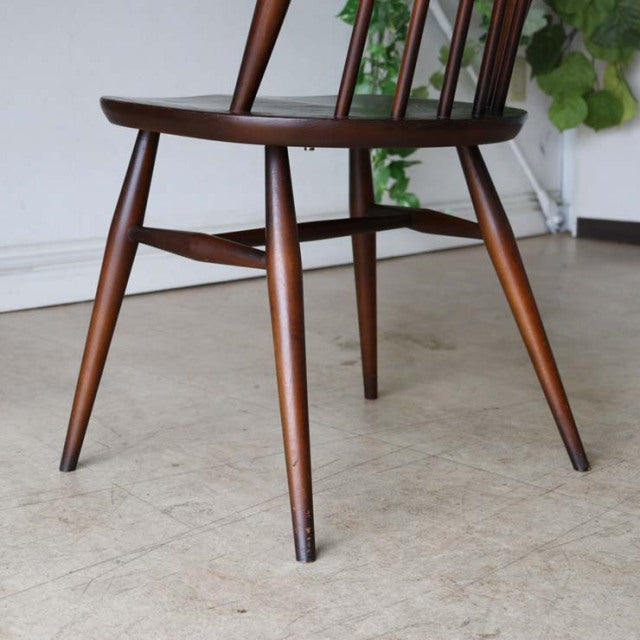 Vintage teak ERCOL Goldsmith mid-century dining chair leg and seat edge with British wood grain finish.