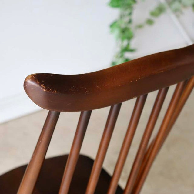 ERCOL Goldsmith Highback Windsor chair in brown teak, showcasing smooth curved top rail and slender spindle backrest with.